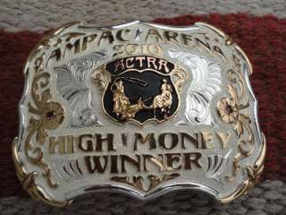   trophy buckle awarded for the high money winner at the ampac arena in