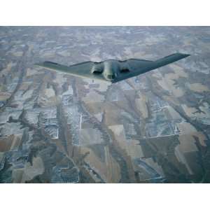 Stealth Bomber Flies Above the Patterned Terrain of Southwestern 