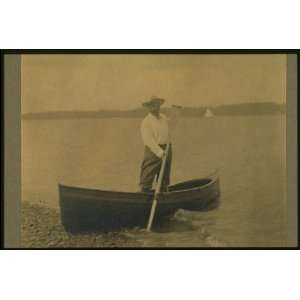 Theodore Roosevelt, standing up in rowboat