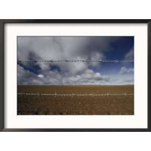  A desolate landscape with barbed wire fence Framed Art 